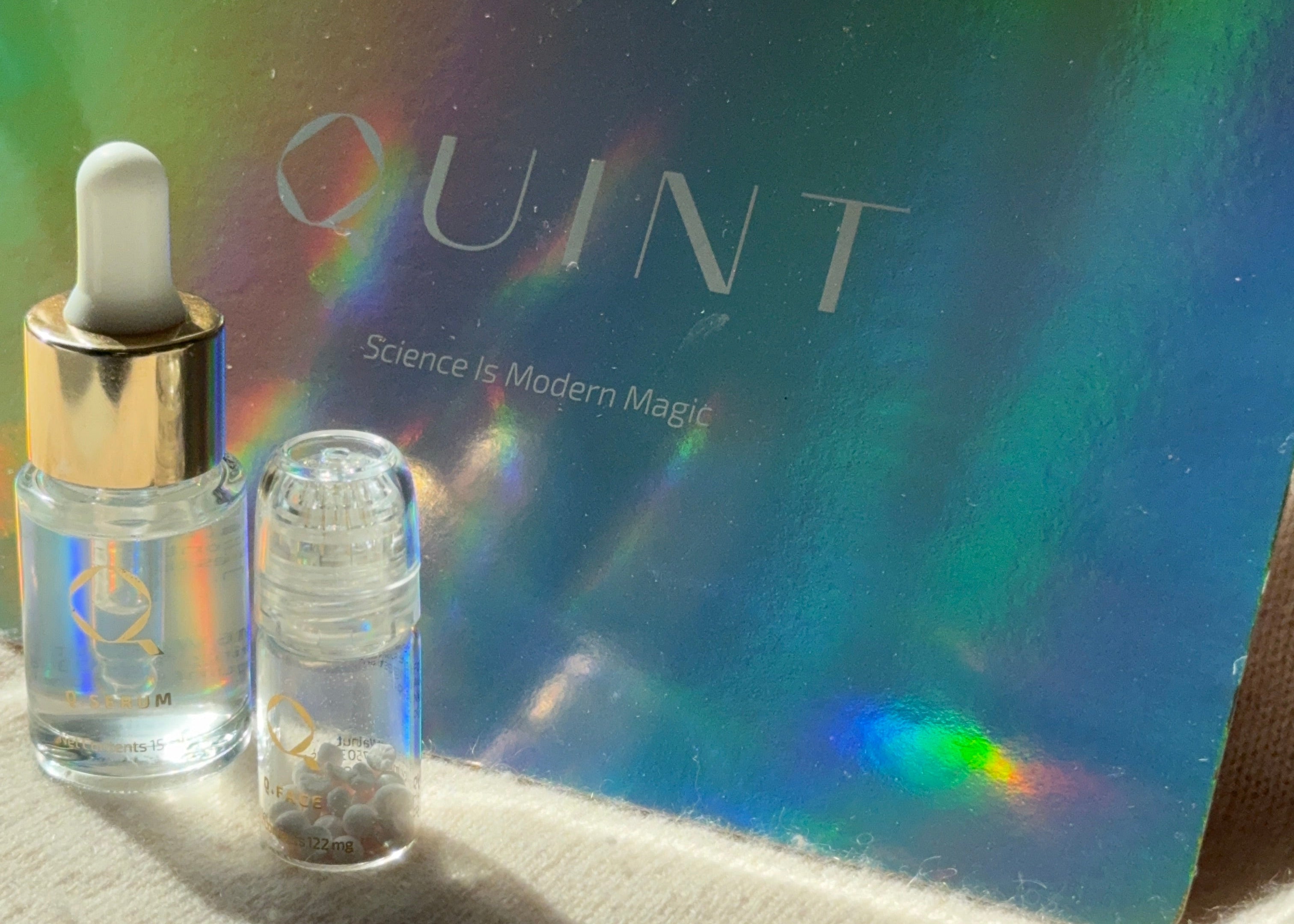 Quint skincare product with dropper on a reflective card