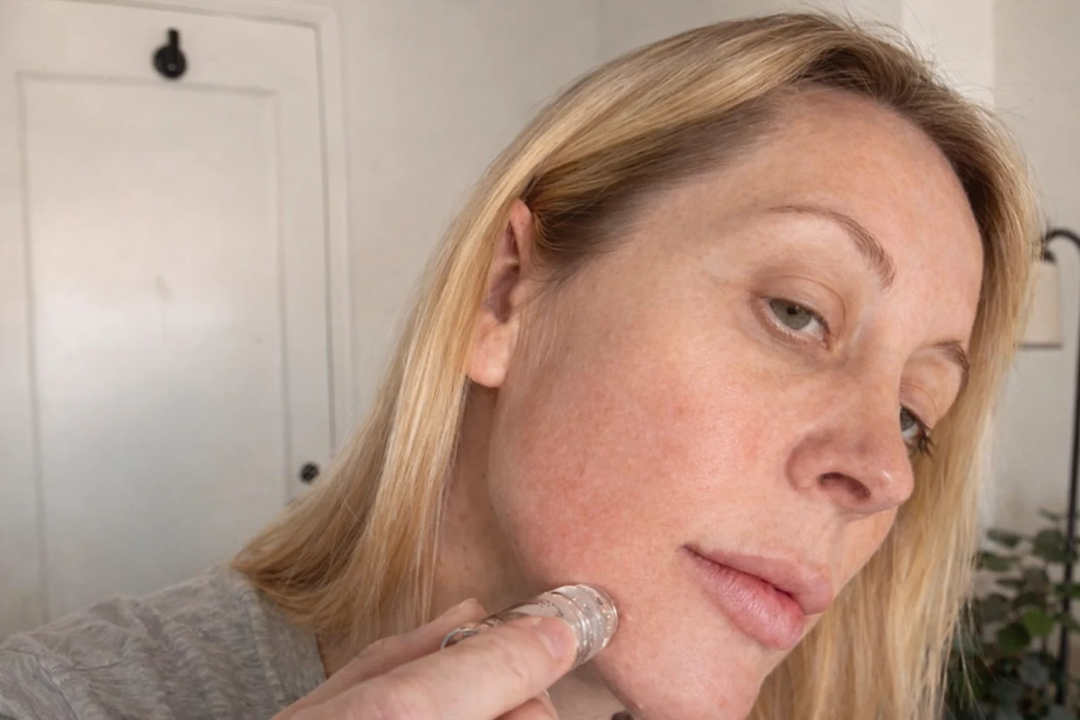 Q.FACE applicator held against the cheek during the demonstration